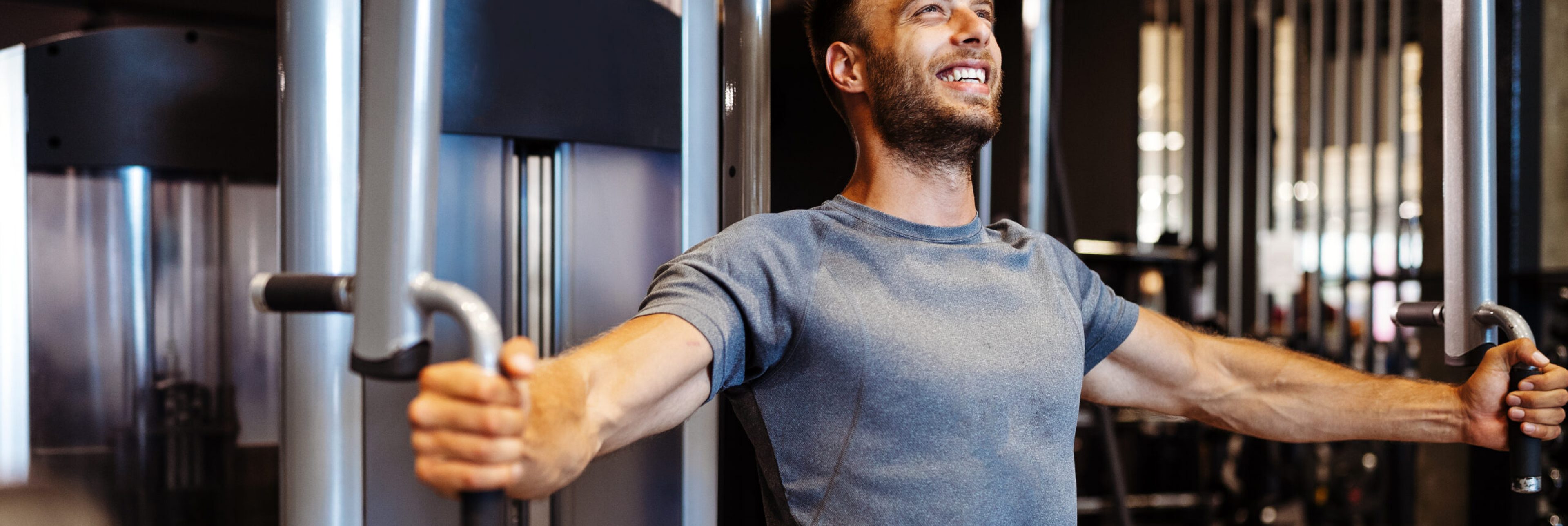 Young man with weight training equipment exercising in sport gym club